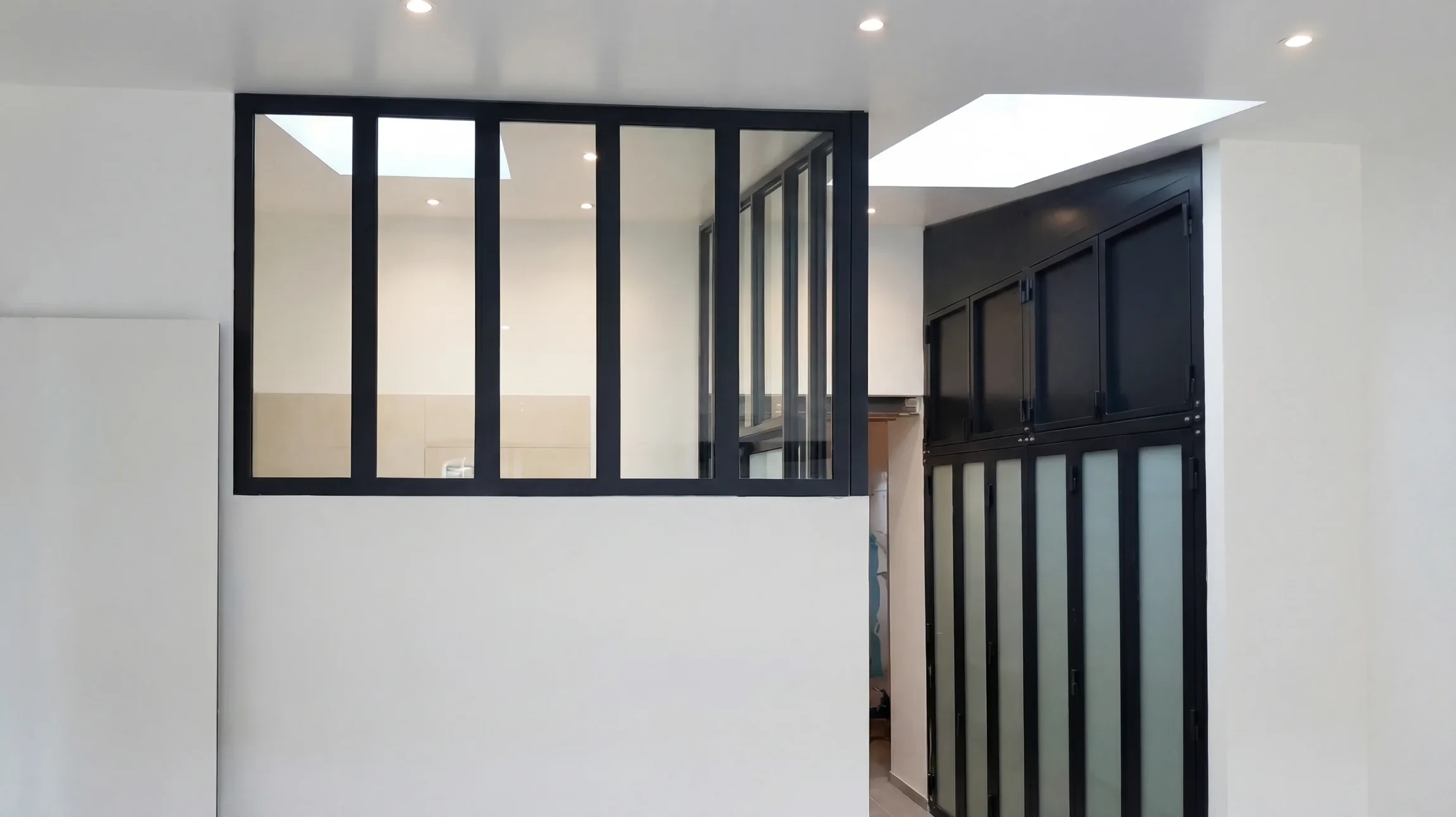Intérieur moderne minimaliste avec verrière d'atelier séparant les espaces